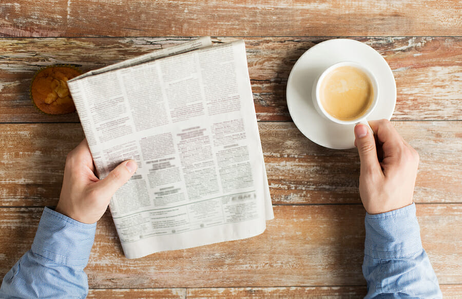 newspaper and a coffee cup